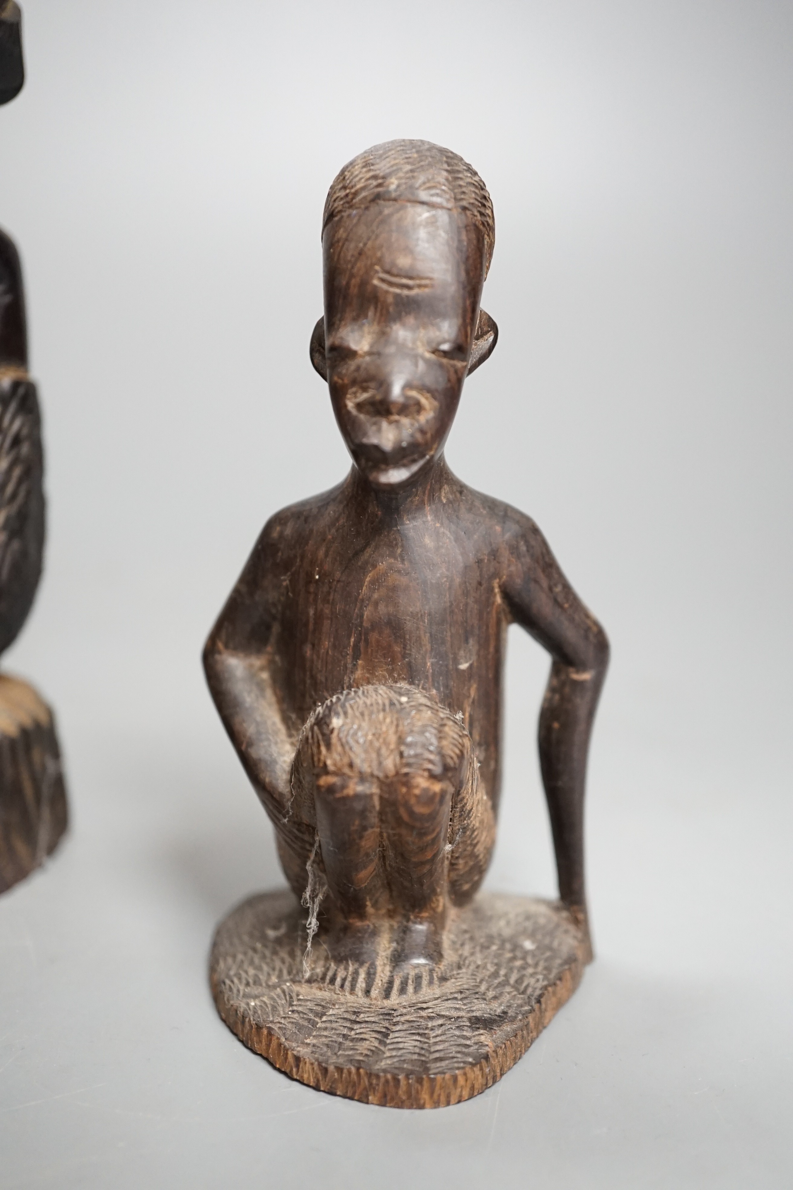 Four tribal hardwood carvings, two bows and two bronze spears longest 85cm